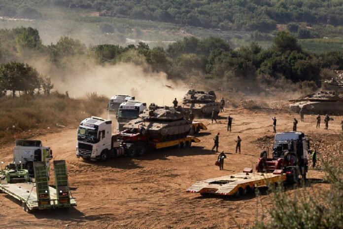 An Israeli Army tank is transported, amid cross-border hostilities between Hezbollah and Israel, in northern Israel