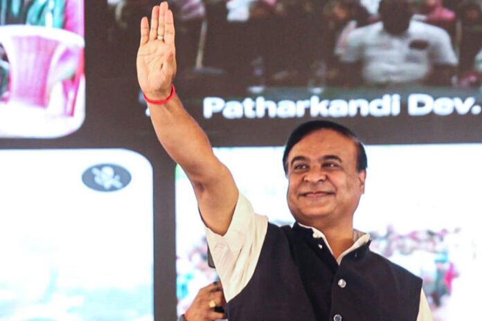 Assam CM Himanta Biswa Sarma waves to the gathering during an event.