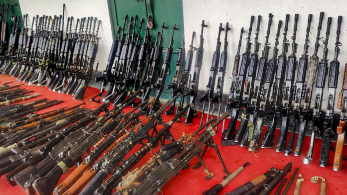 Security forces display recovered weapons and explosives during operation in Manipur