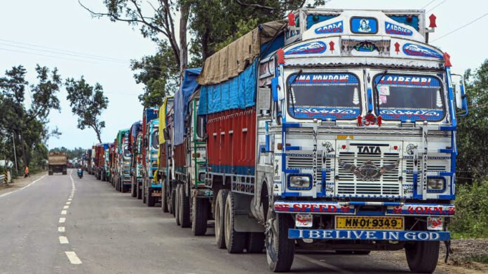 Protesting transport workers and halted trucks following highway security incident in Manipur