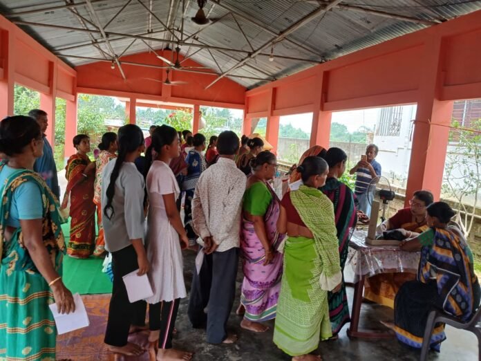 Doctors conducting free medical and eye examinations for residents during community health camp in Agartala.