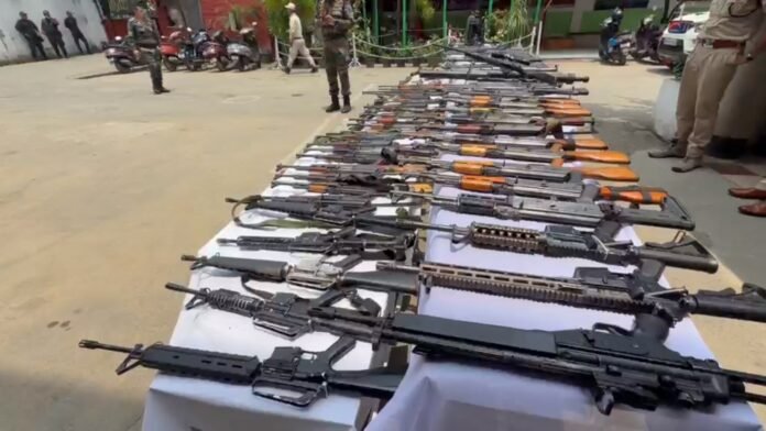 Security personnel displaying recovered weapons during the Manipur Militant Crackdown Operation in the state.