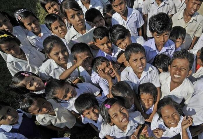 Students and parents gather outside a school amid the Goalpara School Detention Controversy in Assam.