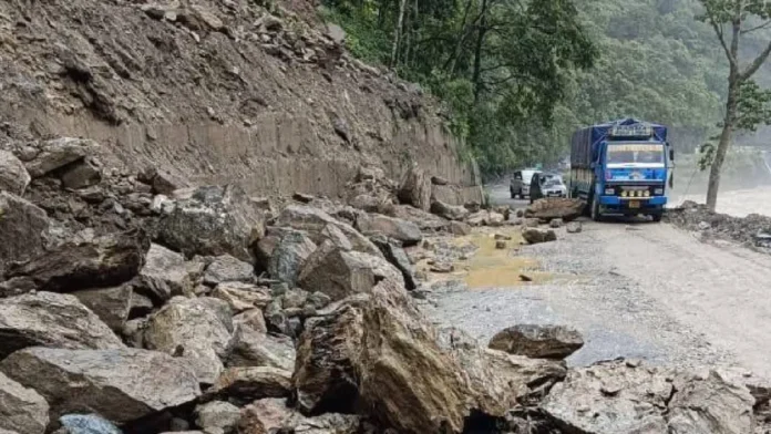 Large mudslide blocking National Highway-10 near Rangpo with debris covering the road and emergency teams working to clear the route.
