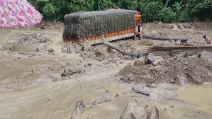 Debris from severe landslides blocking sections of National Highway 6 between Silchar and Agartala during heavy monsoon rainfall.