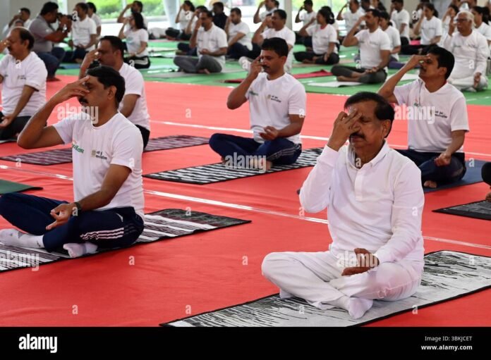 Chief Minister Dr. Manik Saha leading the International Yoga Day mass session at the Hapania International Exhibition Ground in Tripura.