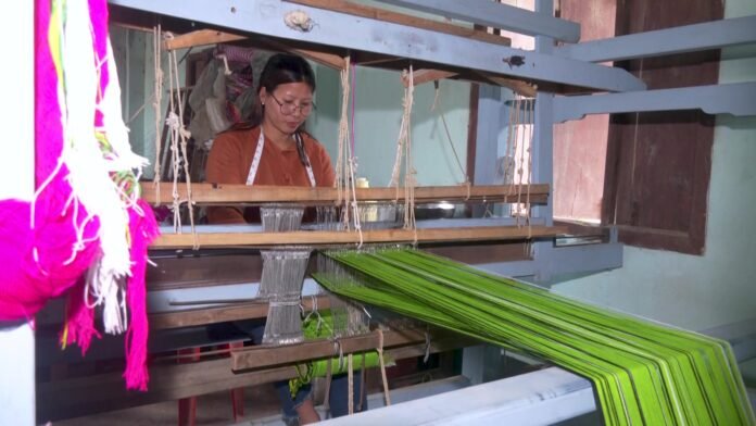 Artisans displaying traditional Naga geometric tribal handloom textiles at an exhibition in Chümoukedima, Nagaland.