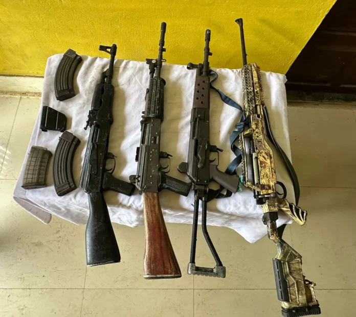 Security personnel conducting a search operation in Churachandpur and recovering an AK-47 assault rifle and explosives after an encounter.