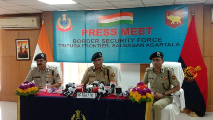 Security personnel conducting checks near an international border crossing in Tripura.