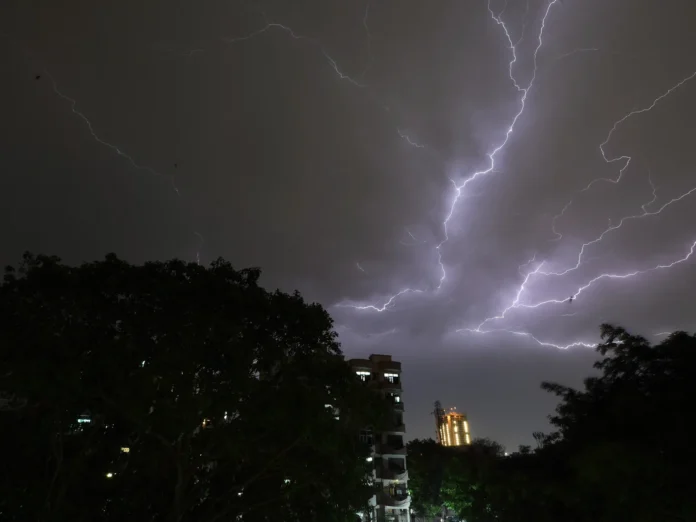 Dark storm clouds and intense lightning strikes over Northeast India as disaster authorities issue emergency stay-at-home advisories.