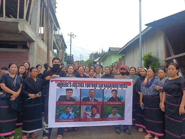 Protesters holding black flags gather in Senapati during demonstrations on July 8, 2026.