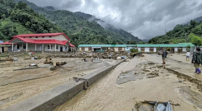 Flood-swollen rivers and severe land erosion damaging roads and infrastructure in mountainous districts of Arunachal Pradesh during the monsoon season.