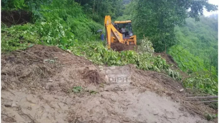 Vehicles navigating a rain-soaked highway in Nagaland amid official warnings of flash floods and landslide risks during the monsoon season.