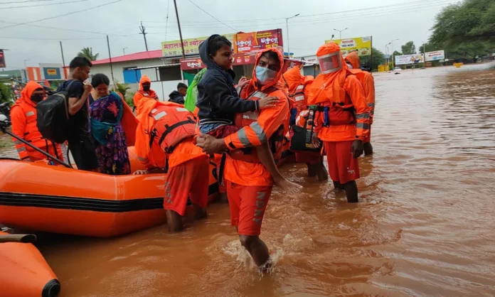 Flood-affected communities receiving emergency assistance as rescue teams operate in heavily inundated areas during the severe monsoon crisis.