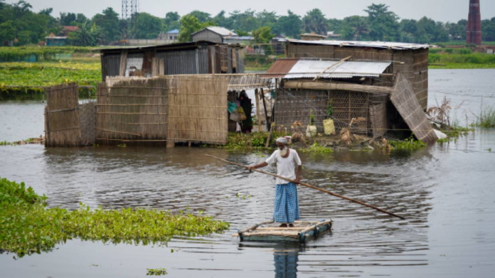 Floodwaters inundating villages in Assam while damaged railway infrastructure near the Simen River remains under emergency inspection.
