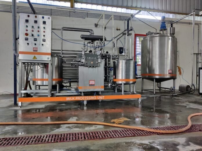 Modern automated milk processing equipment installed by the Manipur Milk Producers' Cooperative Union to enhance dairy production.