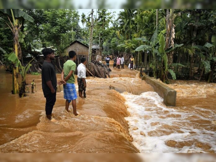 Floodwaters inundating villages and agricultural land in Assam as rescue teams assist displaced residents during the ongoing monsoon crisis.