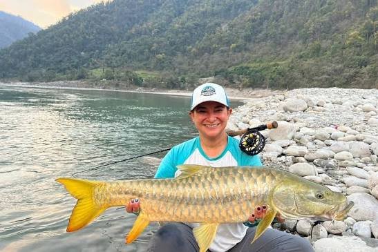 Anglers carefully releasing a 22.9 kg Golden Mahseer back into the Kameng River in Arunachal Pradesh.