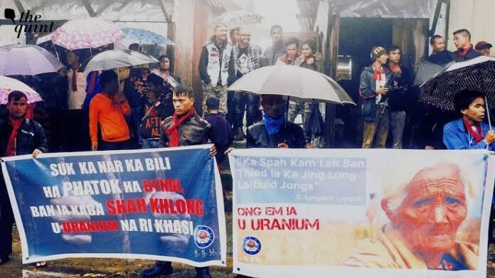 Protesters participate in a peaceful sit-in in Meghalaya while raising concerns over uranium mining and atomic mineral authorities.