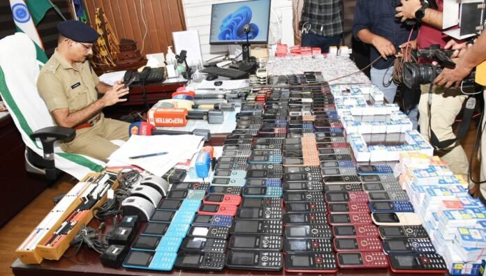 Dhubri Police display seized electronic devices, ATM cards, and mobile phones after busting an alleged online gambling and ATM fraud network.