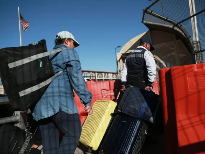 Border officials oversee formal repatriation procedures at an authorized international border crossing.