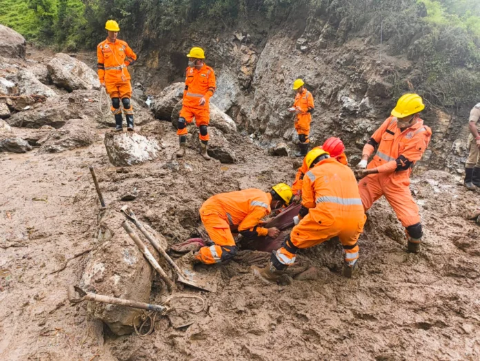 Emergency personnel monitor a landslide-prone mountain highway in Northeast India as heavy monsoon rainfall triggers travel alerts.