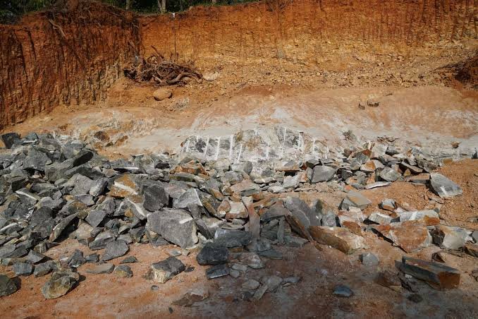 Geological Survey of India officials conduct mineral exploration activities in a hilly landscape in Northeast India to assess lithium and cobalt deposits.