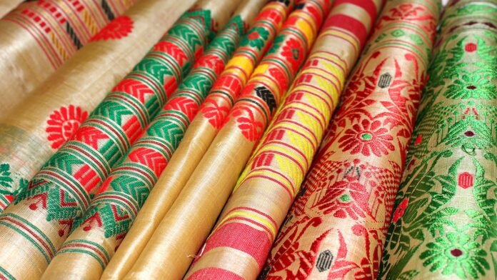 Traditional Muga Silk artisans and weavers showcasing premium silk products under Assam's global branding initiative.