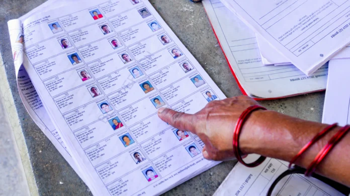 Election officials in Mizoram review draft electoral rolls as citizens verify voter details during the public revision process.