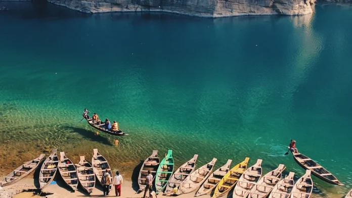 Tourist boats operate on the clear waters of the Umngot River at Dawki as local operators promote strict zero-littering practices.