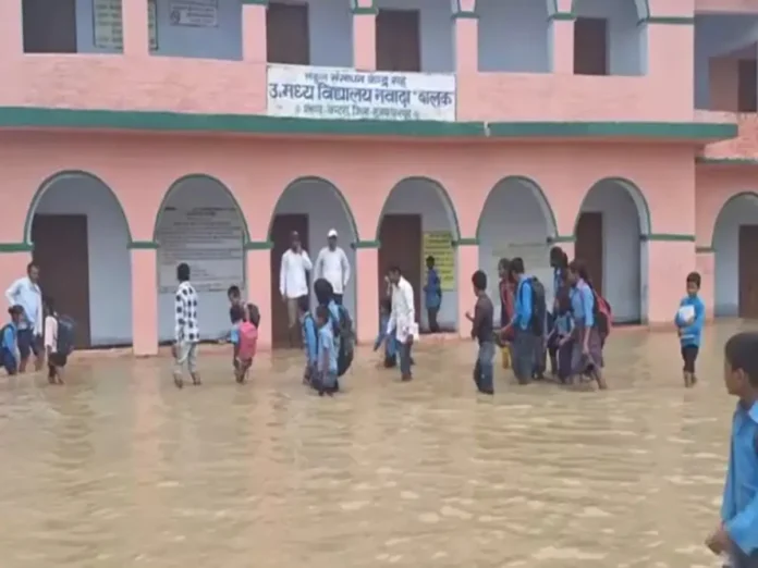 Floodwater submerges school buildings as education boards consider extending the summer break for affected students.