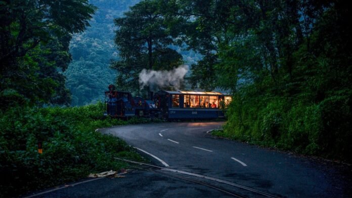 Darjeeling Himalayan Railway Toy Train travelling through the scenic hills of Darjeeling, West Bengal.