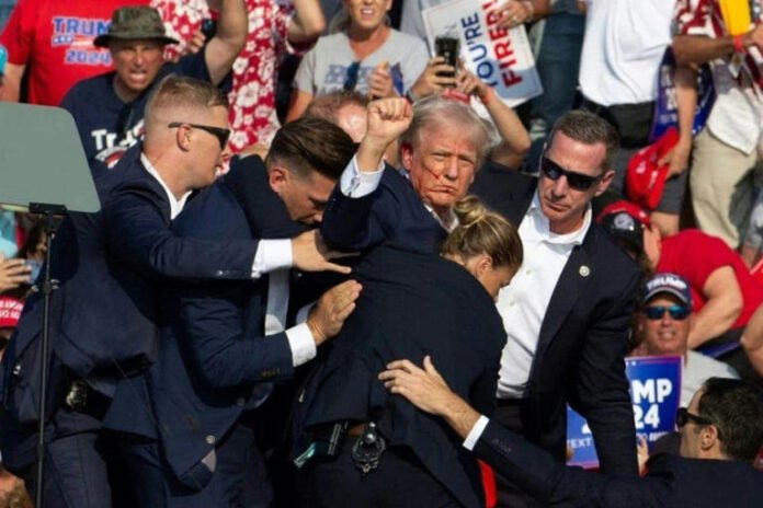 Secret Service agents shield Donald Trump during an assassination bid on the former President. (AFP)